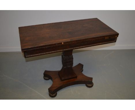 A William IV rosewood card table stamped Gillows, the hinged rectangular top, with Gillow's stamp to the underside, above a c