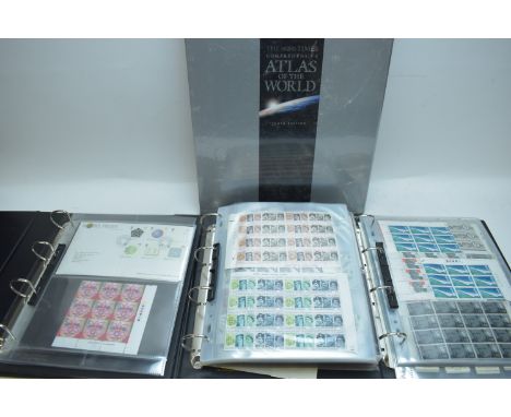 Two albums of first day covers and other stamps; one album of stamps and cigarette cards; and a Times Atlas of the World.