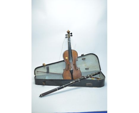 A vintage violin with a label to the interior 'Manufactured in Dresden, imitation of Antonius Stradivarius', with a bow, case