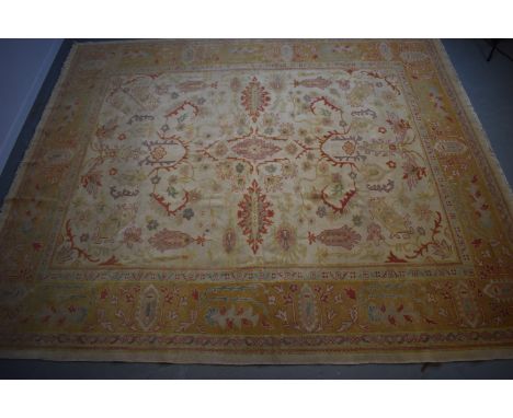 A Ziegler style carpet, the ivory ground with foliate meaders, enclosed by a repeating foliate border, 312 x 271cms.