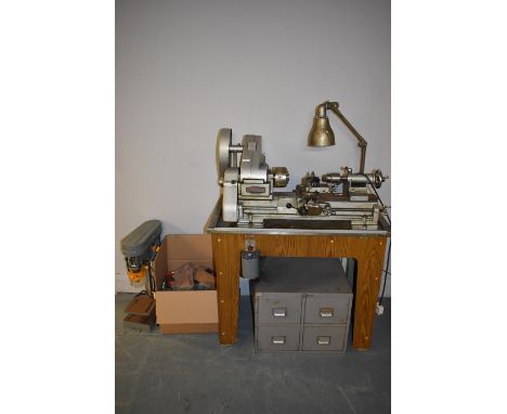 A Myford ML 10 Lathe and accessories, the lathe raised on a table stand, with light and box of accessories, 120 x 82 x 54cms.
