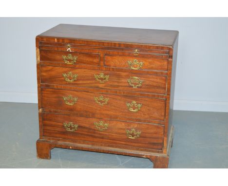 A George III mahogany bachelor's chest, the caddy top above a brushing slide and arrangement of two short over three long gra