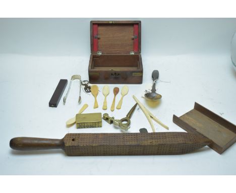 A pair of early Victorian Silver Newcastle sugar tongs; a set of sovereign scales; a brass stamp box; bone and horn spoons; a