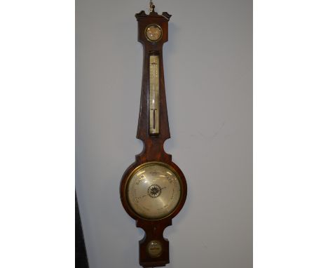 A 19th Century mahogany wheel barometer, with silvered circular dial and silvered thermometer, contained within a mahogany ca