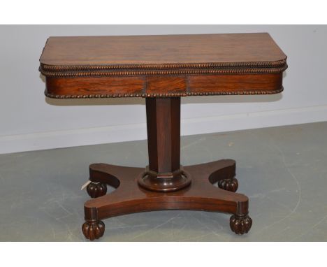 A Victorian rosewood card table, with hinged rectangular top with beaded edge, enclosing a baize-lined interior, the undersid