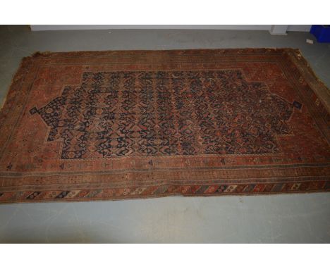 A Caucasianan carpet, with indigo ground and stylised flowerhead, contained within a repeating border, 355 x 208.5cms.