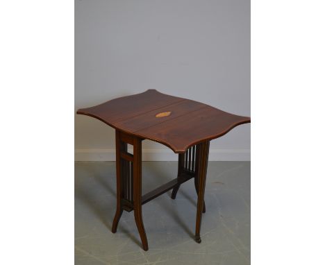 An Edwardian mahogany Sutherland table, the rectangular top inlaid with shell motif and two shaped drop leaves, raised on out