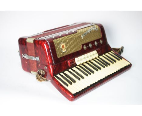A Marinucci 120 Bass piano accordion with twenty-four treble keys and seven selector buttons, Selmer faux crocodile case.