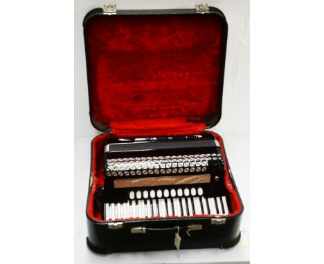 A Hohner Atlantic IVN Musette 120 bass piano accordion, red plush-lined case.