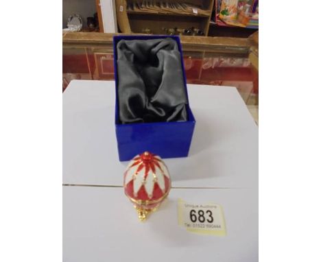 A boxed enamel and gilt egg pill box.