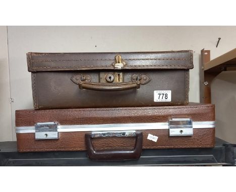 A small vintage suitcase and a brief case.