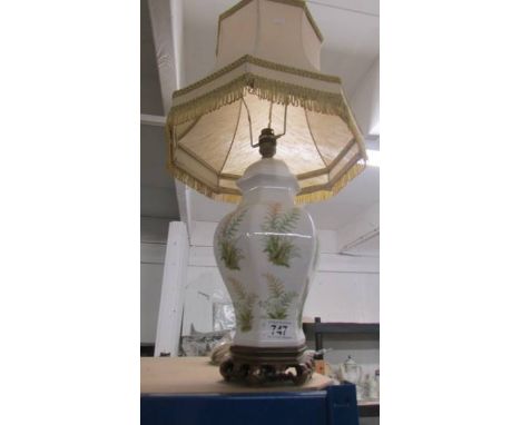 A ceramic table lamp with shade.