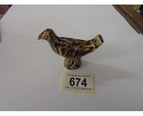 A ceramic bird whistle.