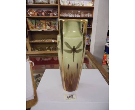 A gilded ceramic vase decorated with dragon flies.