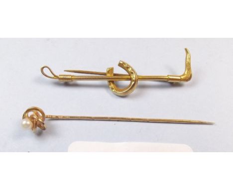 A 9 carat gold riding crop form stock pin and an 18 carat gold pearl set stick pin