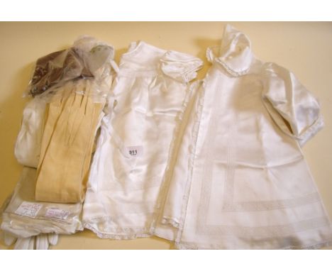 A box of gloves and vintage christening dress and coat