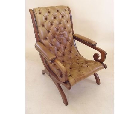 A 20th century button upholstered mahogany framed leather library chair