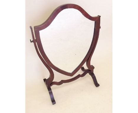 A mahogany shield form toiletry mirror