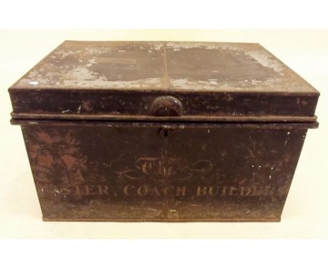 A tin trunk marked 'The Master Coach Builders'