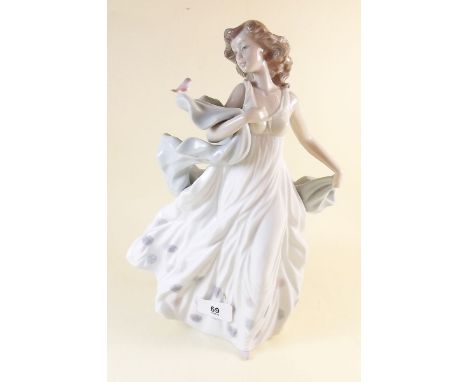 A Lladro figure woman in evening dress with bird