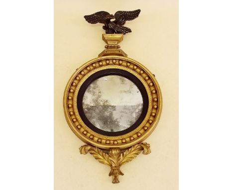 An 19th century circular convex gilt framed mirror with ball surround and eagle surmount 47cm diameter x 86cm tall