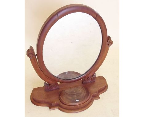 A Victorian oval mahogany swing toiletry mirror