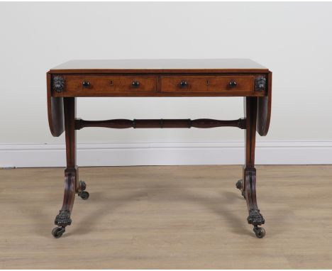 A REGENCY INLAID MAHOGANY TWO DRAWER SOFA TABLEWith lion mask decoration, 90cm wide; 151cm wide open; 54cm deep; 73cm high