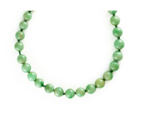 A SINGLE ROW NECKLACE OF GRADUATED JADE BEADSOf integral form without a clasp, diameter of largest bead 0.9cm, diameter of sm