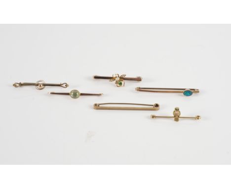 SIX BAR BROOCHES (6)Comprising; a two colour gold bar brooch, with an owl motif, having green gem set eyes, detailed 9 CT, a 