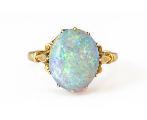 AN OPAL RING (2)Claw set with oval cabochon opal measuring 14.4mm x 11.6mm, with scrollwork shoulders, mounted in unmarked go