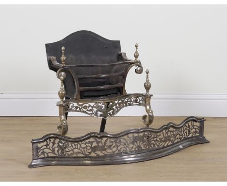 A GEORGE III STYLE STEEL PIERCED SERPENTINE FENDER AND FIRE GRATE (2)19th and 20th Century  The fender with scrolling foliate