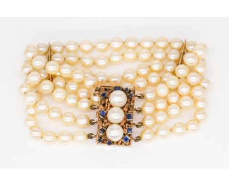 A FOUR ROW BRACELET OF CULTURED PEARLSOn a gold, sapphire and cultured pearl rectangular clasp, detailed 14 K, length 18.8 cm