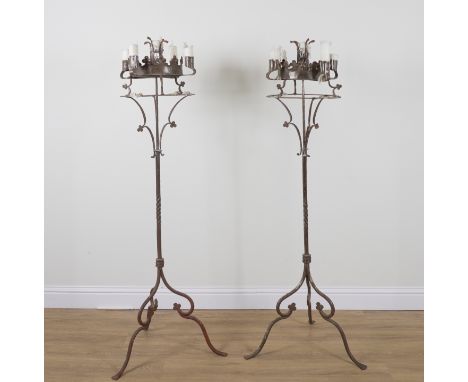 A PAIR OF GOTHIC REVIVAL POLISHED STEEL FLOOR STANDING CANDELABRA (2)20th Century Each with four candlestick holders arranged