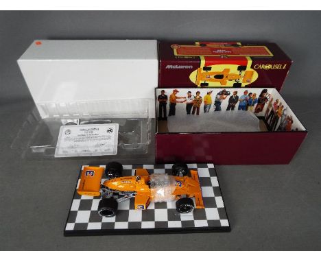 Carousel - A boxed 1:18 scale McLaren M16 1974 Indianapolis 500 winner number 3 Johnny Rutherford car. # 4801. The car appear