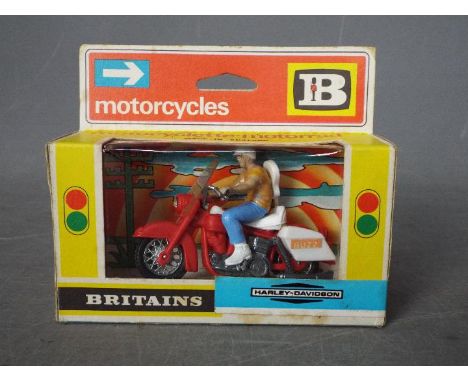 Britains - A boxed Britains #9689 Harley Davidson. The model in red with white plastics, rider figure with guitar on back app