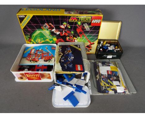 LEGO - A vintage Lego #6989 M-Tron Set, together with three containers of loose Lego bricks and parts, including Lego #6385 F