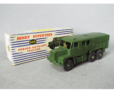 Dinky Toys - A boxed Dinky Toys #689 Medium Artillery Tractor with both spare tyres in rear plus driver, with some light chip