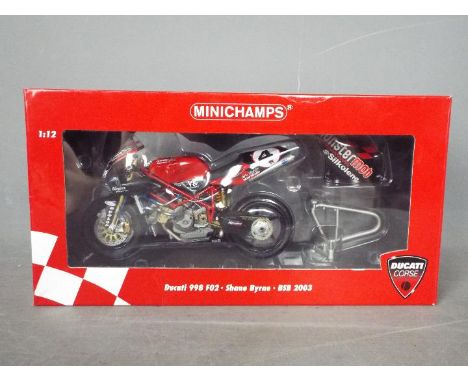 Minichamps - A 1:12 scale Ducati 998 FO2 - Shane Byrne BSB 2003. The model appears Mint in a Very Good box with light storage