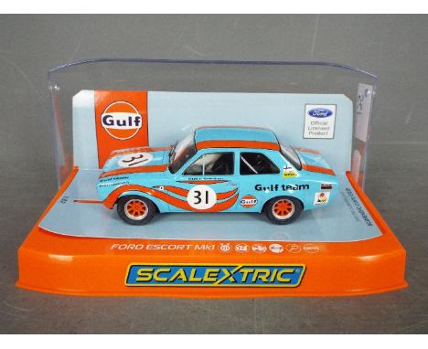 Scalextric - A Ford Escort MkI in Gulf Team livery, # C4013. The car appears Mint in a Very Good perspex display case with on