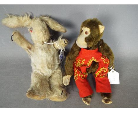 Unconfirmed Maker - Two vintage soft toys. Lot includes a vintage, jointed, brown 'Jacko' monkey standing approximately 25cms