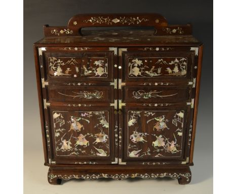 A Chinese hardwood and mother-of-pearl marquetry table cabinet, arched handle above a pair of rectangular doors enclosing an 