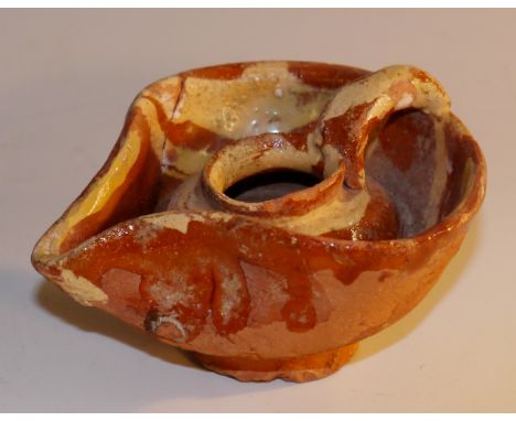 Antiquities - a Medieval Syrian-Arabic terracotta oil lamp, of pinched form, decorated with trailed buff slip, 9.5cm wide

Pr