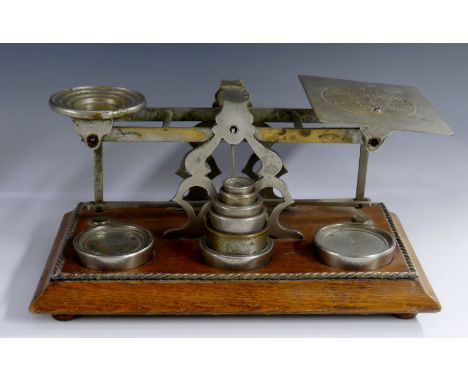 A set of Victorian oak letter scales, the plateaux inscribed Book Post up to 5lbs and Inland Letter Post, moulded base with r