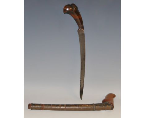 An Indonesian kris, 25.5cm plain curved single-edged blade, well figured hardwood grip carved as a stylised lotus blossom, si