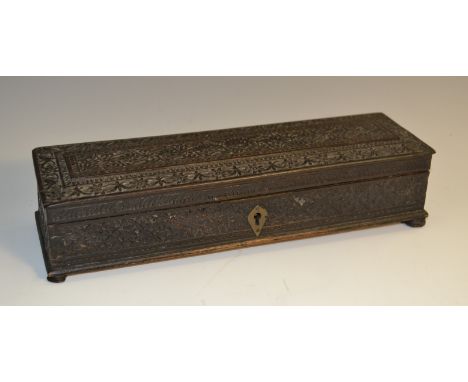 A 19th century Anglo-Indian ebony scribe's box, carved overall with flowerheads and meandering foliage, hinged cover enclosin