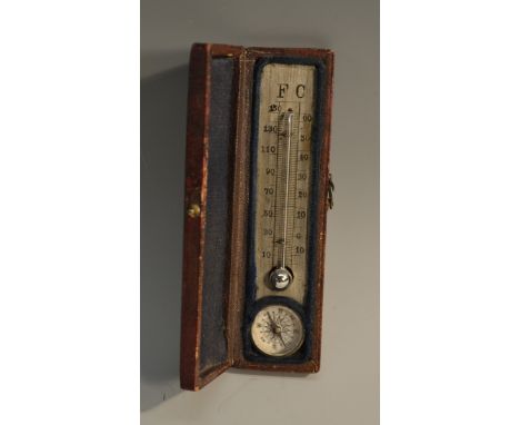 A 19th century morocco leather travelling pocket compass and thermometer, hinged cover enclosing a silvered register, 10.5cm 