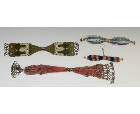 A 19th century beadwork miser's purse, decorated in white and black with arrow and chevron motifs on a moss green ground, .34