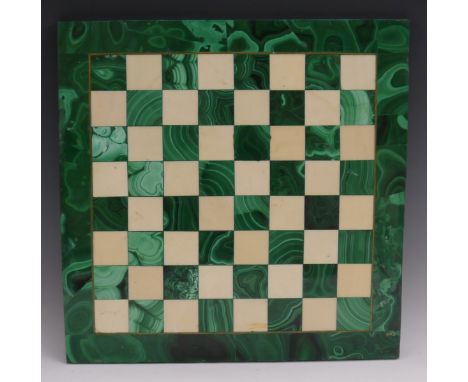 A malachite chess board, the field outlined with brass stringing, 34.5cm square 