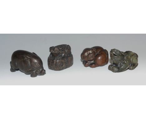 A Japanese hardwood netsuke, carved as a boar, 5.5cm long, signed; others, a toad, a dog; another, Chinese hardstone (4) 
