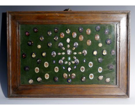 An arrangement of 18th and 19th century cameos, miniature plaques and button tops, various materials and forms of decoration,